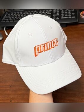 Prince White Baseball Cap with Orange Embroidered Tito’s Logo